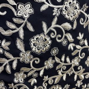 Tejido, bordado, fondo negro con hilo de color oro